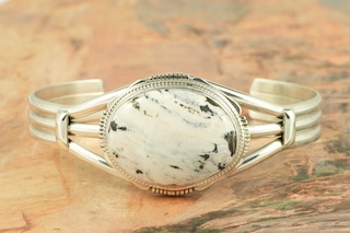 White Buffalo Turquoise Set in Sterling Silver Bracelet. This Beautiful Stone is formed from the minerals Calcite and Iron. It is mined near Tonopah Nevada. Created by Navajo Artist Kathy Yazzie. Signed by the artist.